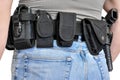 Military tactical belt with semi-automatic buckle for connection with cartridge pouch, placed on man`s belt, isolated - back view