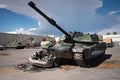 a military tank driving over a car