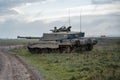 Military tank moving in a field Royalty Free Stock Photo