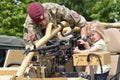 Military Tattoo COLCHESTER ESSEX UK 8 July 2014: Small Girl being shown machine gun Royalty Free Stock Photo