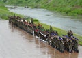 Military, training or bootcamp with people in the rain for a drill at a parade as a special forces squad. Army, soldier