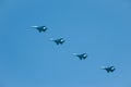 Military Ukrainian fighter jet flies against the blue sky.