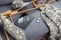 military uniform with crutches and a tablet