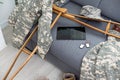 military uniform with crutches and a tablet