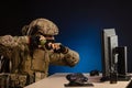 Military in uniform sitting at a computer are cyberwar, playing, throwing a grenade