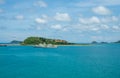 Military warships are stationary beside a small island. against a background of green mountains and clear skies in the Gulf of