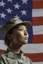 Military woman in front of US flag, vertical Military woman in front of US flag, vertical Royalty Free Stock Photo