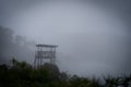 Military Wooden watch tower in the jungle surrounded by mystic fog. Dangerous concept