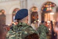 Military young man in the Easter night during church service.