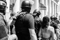 Militia Members in Combat Gear Move Through a Crowd Towards a Counter Protestor