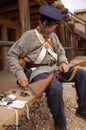 Soldier militiaman from 1800's assembles a musket at Bent's Fort historical reenactment