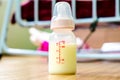Milk in baby bottle on wooden floor background Royalty Free Stock Photo