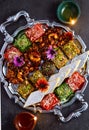 Indian Sweets - vintage silver tray with Burfi and earthen lamps Royalty Free Stock Photo