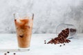 Milk Being Poured into Iced Coffee in Tall Glass on Light Grey Background. Concept Refreshing Summer Drink Royalty Free Stock Photo