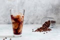 Milk Being Poured into Iced Coffee in Tall Glass on Light Grey Background. Concept Refreshing Summer Drink Royalty Free Stock Photo