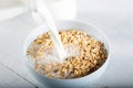 Milk being poured over a bowl of cereal. Royalty Free Stock Photo