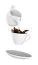 Milk being poured into small cup of coffee. white background