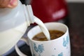 Milk being put in to coffee