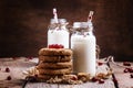 Milk beverages in glass bottles, crisp cookies with pomegranate