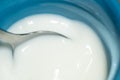 Milk in a blue cup with a metal spoon Royalty Free Stock Photo