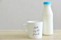 Milk bottle and a white mug