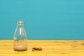 Milk bottle with dregs of chocolate milkshake and cookie crumbs Royalty Free Stock Photo