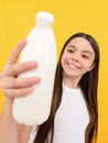 milk bottle in hand of happy child. kid hold dairy beverage product.