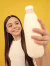 milk bottle in hand of happy child. kid hold dairy beverage product.