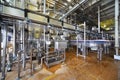 Milk bottles move through long pipeline in factory