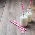 Milk bottles with retro striped straws Royalty Free Stock Photo