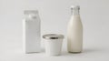 Milk carton, yogurt container, and glass milk bottle are arranged on a plain background Royalty Free Stock Photo