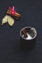 Milk chai tea with cinnamon on black background