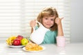 Milk for children. Fuuny little boy pouring whole milk for breakfast. Child boy eating organic healthy milk. Healthy