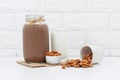 Milk Chocolate and Almonds in a glass on white background Royalty Free Stock Photo