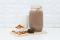 Milk Chocolate and Almonds in a glass on white background Royalty Free Stock Photo