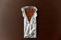 Milk chocolate bar with nuts in foil wrapper Royalty Free Stock Photo