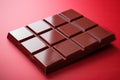 Milk chocolate bar on a red background.