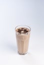 Milk-chocolate cocktail in a tall glass with a straw on white background Royalty Free Stock Photo