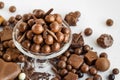 Milk chocolate covered hazelnuts with grated chocolate chips in an elegant bowl