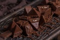 Milk chocolate. Milk chocolate pieces on a wooden background