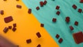 Chocolate chunks falling on colorful floor 3d illustration 3d rendering Royalty Free Stock Photo