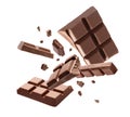 Milk chocolate pieces falling on background Royalty Free Stock Photo