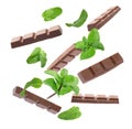 Milk chocolate pieces and mint falling Royalty Free Stock Photo