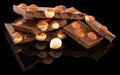 Milk chocolate pieces with nuts on a dark background Royalty Free Stock Photo