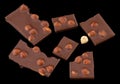 Milk chocolate pieces with nuts on a dark background Royalty Free Stock Photo