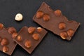 Milk chocolate pieces with nuts on a dark background Royalty Free Stock Photo