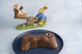 Milk chocolate in the shape of a video game controller alongside small rabbits_1 Royalty Free Stock Photo