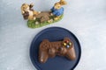 Milk chocolate in the shape of a video game controller alongside small rabbits_2 Royalty Free Stock Photo