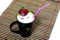 Milk cocktail in a black mug, is decorated with strawberry Royalty Free Stock Photo