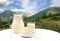 Milk and cottage cheese on background of landscape mountains